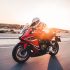 Biking a red motorcycle in the sunset with high speed